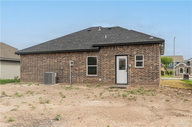 back of house featuring central AC unit