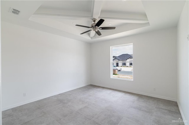 empty room with a tray ceiling and ceiling fan