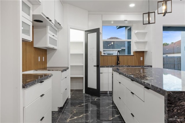 kitchen with white cabinetry and pendant lighting