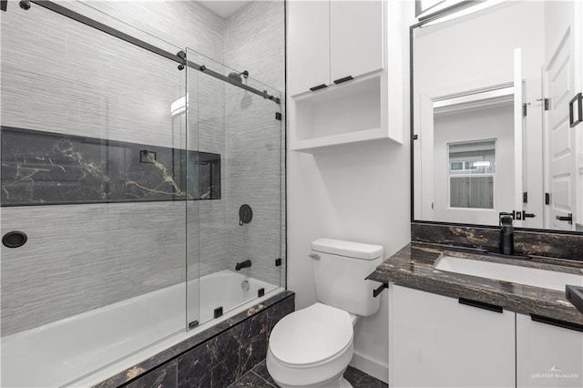 bathroom with vanity and enclosed tub / shower combo