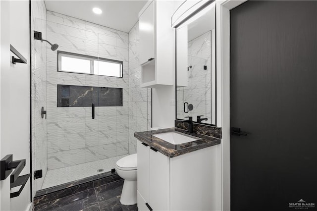 bathroom with vanity, toilet, and an enclosed shower