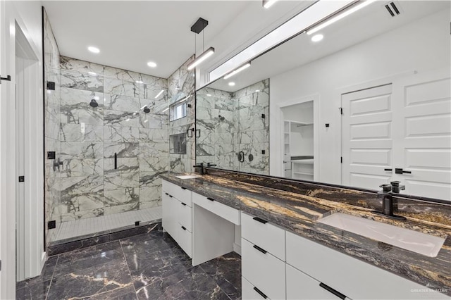 bathroom with vanity, an enclosed shower, and tile walls