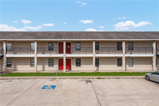 view of property featuring uncovered parking