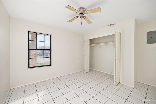 unfurnished bedroom with light tile patterned floors, a closet, visible vents, a ceiling fan, and electric panel