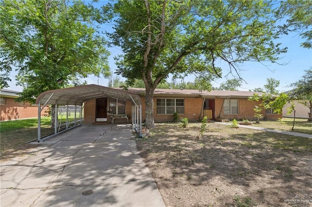 1215 Oak St, Mission, TX 78572 - view of front of home with driveway, a carport, and brick siding