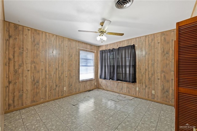 1215 Oak St, Mission, TX 78572 - unfurnished room with a ceiling fan, wooden walls, baseboards, and tile patterned floors