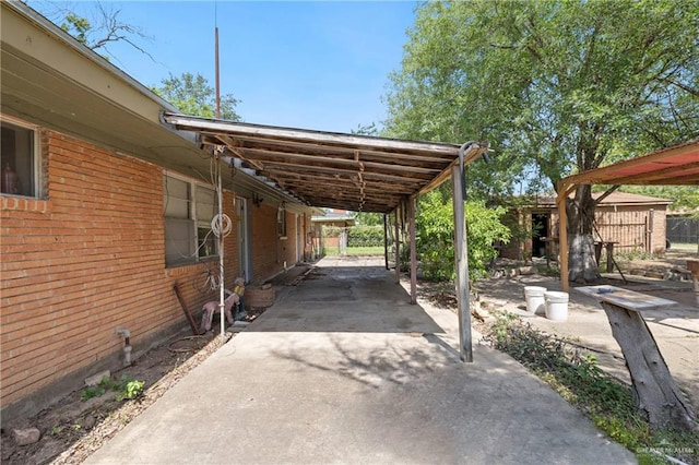 1215 Oak St, Mission, TX 78572 - view of parking featuring a carport and concrete driveway
