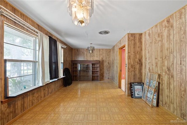 1215 Oak St, Mission, TX 78572 - hall featuring a chandelier, tile patterned floors, and wooden walls