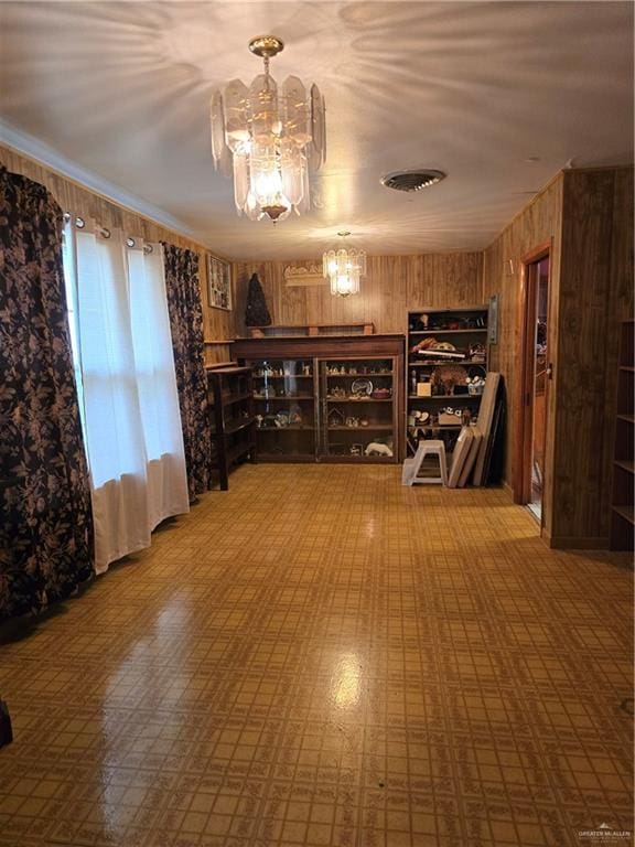 1215 Oak St, Mission, TX 78572 - wine area featuring a chandelier and wooden walls