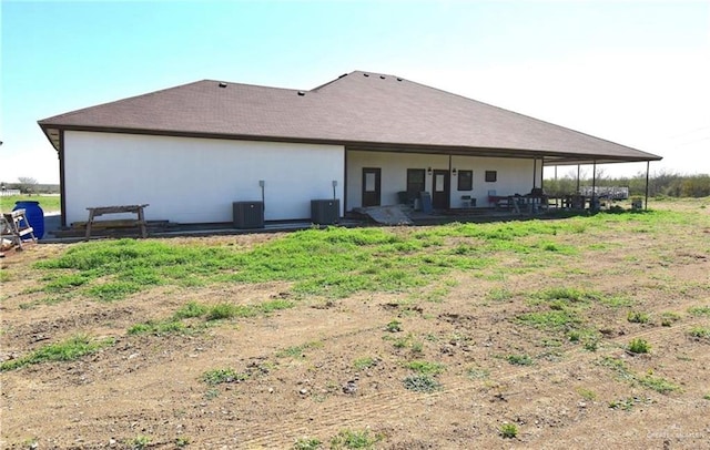 back of house with cooling unit and a patio