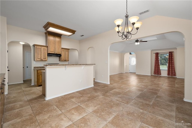 2002 Butkus Dr, Edinburg, TX 78542 - kitchen with arched walkways, a ceiling fan, open floor plan, and under cabinet range hood