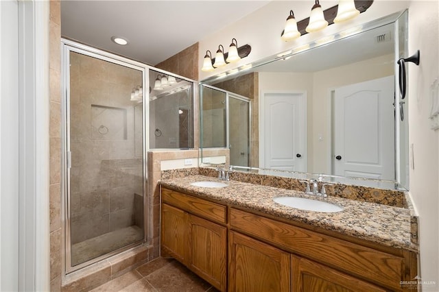 2002 Butkus Dr, Edinburg, TX 78542 - bathroom with a shower stall, double vanity, and tile patterned flooring