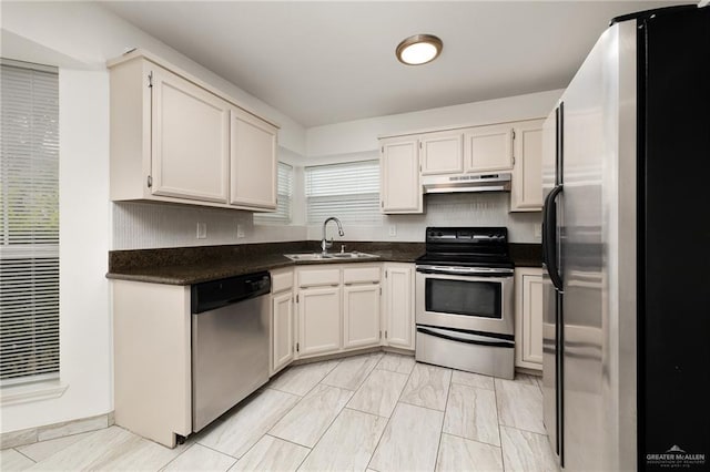 kitchen featuring white cabinetry, sink, and appliances with stainless steel finishes