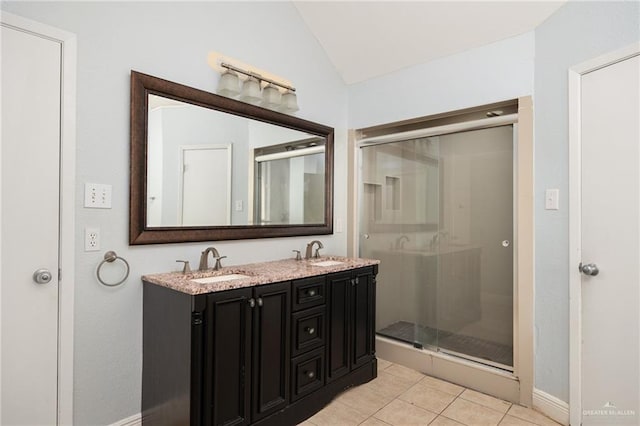 bathroom featuring tile patterned flooring, vanity, a shower with shower door, and lofted ceiling