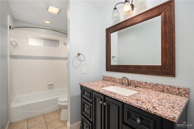 full bathroom with tiled shower / bath, tile patterned flooring, vanity, and toilet