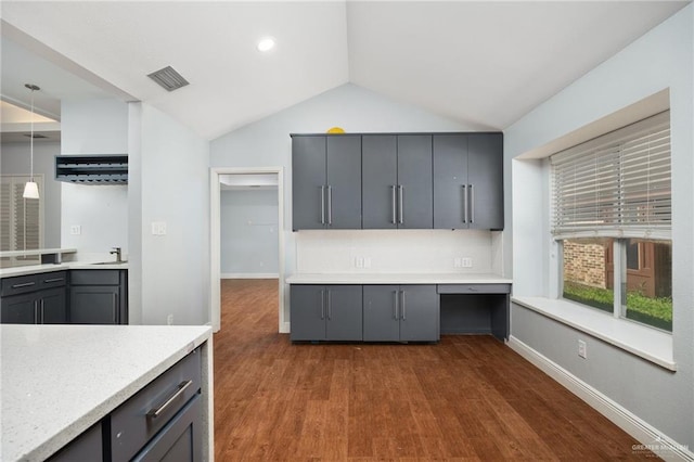 kitchen with gray cabinets, dark wood-type flooring, and lofted ceiling