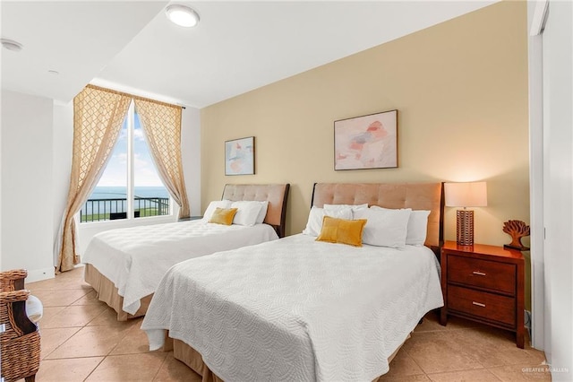 310A Padre Blvd Unit 2304, South Padre Island, TX 78597 - bedroom with access to exterior, light tile patterned floors, and a water view