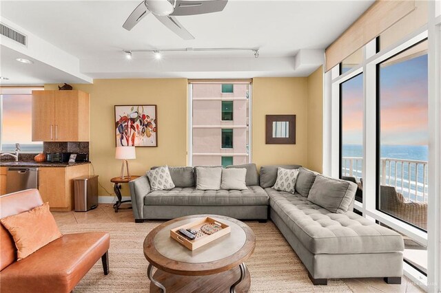 310A Padre Blvd Unit 2304, South Padre Island, TX 78597 - living room featuring track lighting, healthy amount of natural light, ceiling fan, and light tile patterned floors