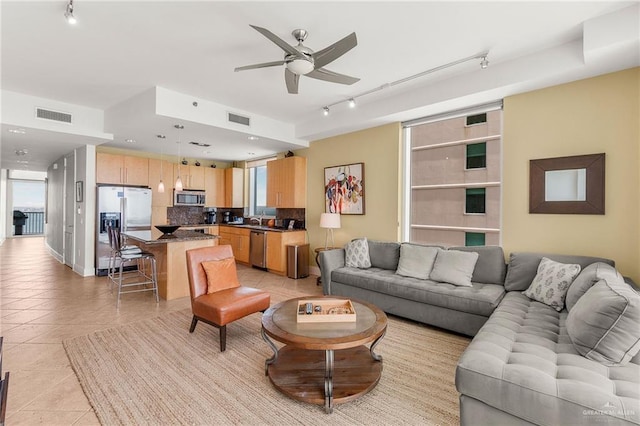 310A Padre Blvd Unit 2304, South Padre Island, TX 78597 - living area with track lighting, ceiling fan, and light tile patterned floors