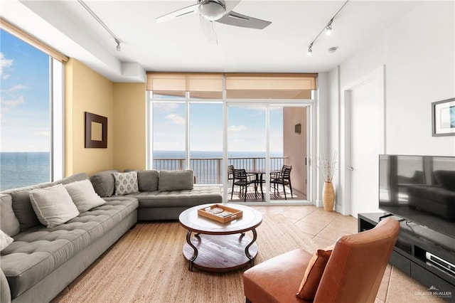 310A Padre Blvd Unit 2304, South Padre Island, TX 78597 - living area featuring rail lighting, expansive windows, light tile patterned floors, a water view, and ceiling fan