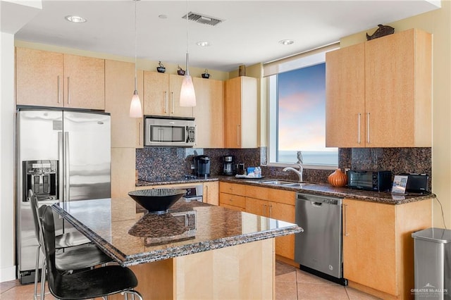 310A Padre Blvd Unit 2304, South Padre Island, TX 78597 - kitchen with stainless steel appliances, light tile patterned flooring, dark stone countertops, tasteful backsplash, and recessed lighting