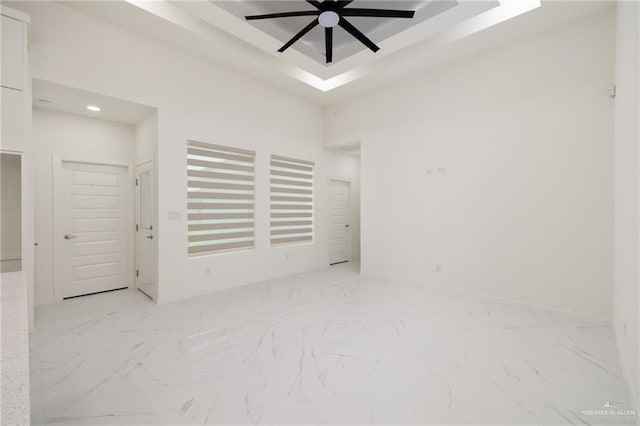 2810 E Uva Ave, Hidalgo, TX 78557 - spare room with ceiling fan, light marble finish floors, recessed lighting, a tray ceiling, and baseboards