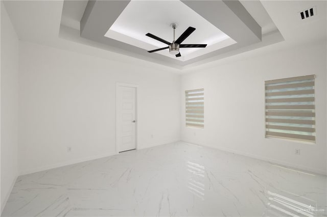 2810 E Uva Ave, Hidalgo, TX 78557 - unfurnished room with a raised ceiling, a ceiling fan, marble look tiles, and baseboards