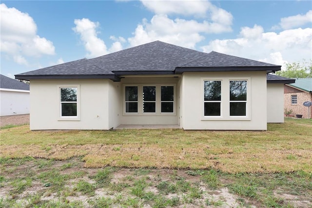 rear view of property with a yard