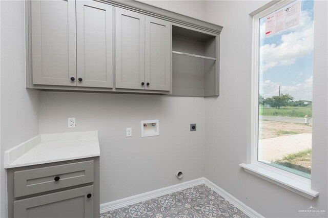 washroom featuring tile patterned floors, washer hookup, cabinets, and hookup for an electric dryer