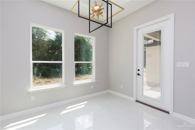 interior space featuring plenty of natural light and an inviting chandelier