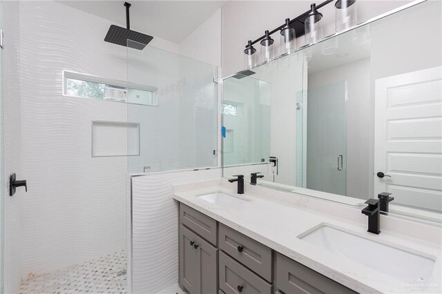 bathroom with vanity and a shower with door