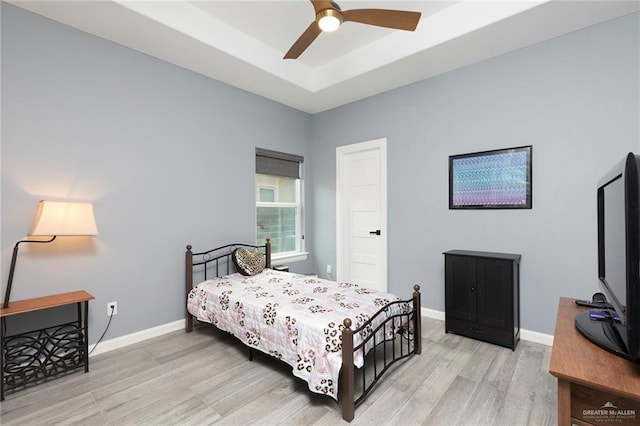 1803 Lago Michigan St, Edinburg, TX 78542 - bedroom with light wood-style floors, a raised ceiling, and a ceiling fan