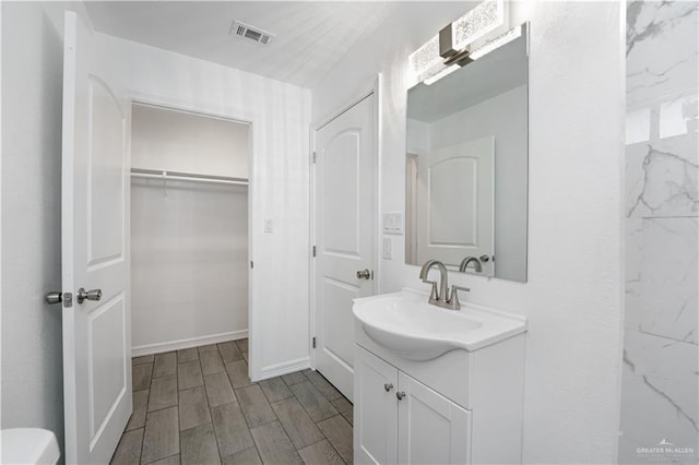 bathroom with vanity and wood-type flooring