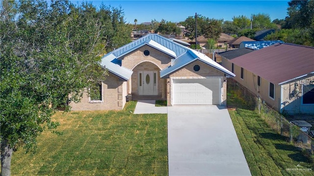 view of front of home with a garage and a front lawn