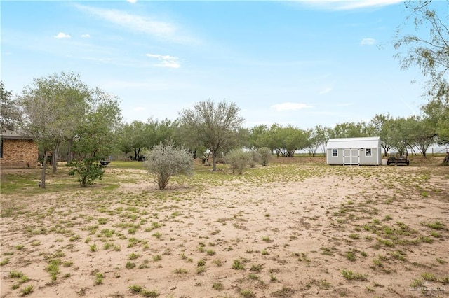 view of yard featuring a storage unit and a rural view