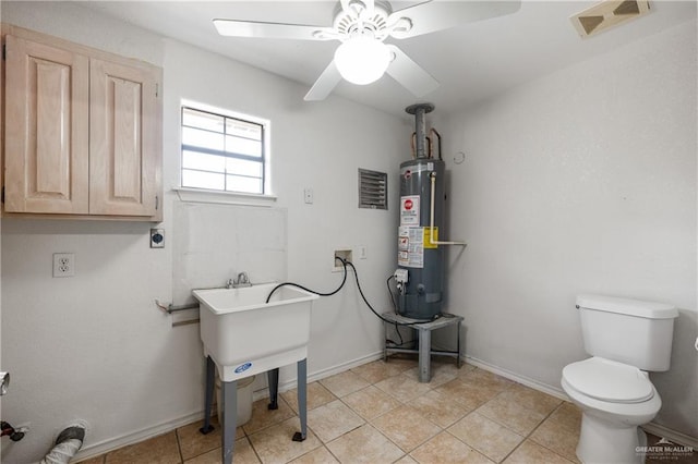 laundry room with light tile patterned floors, hookup for a washing machine, water heater, and ceiling fan