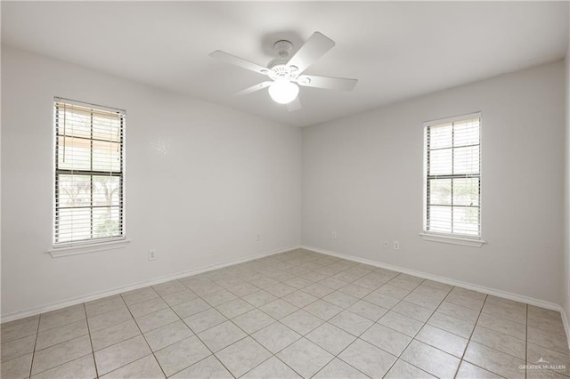 spare room featuring a wealth of natural light and ceiling fan