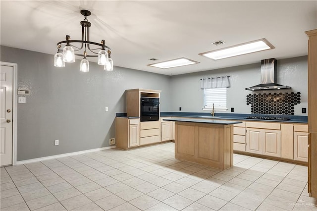 kitchen featuring black appliances, light brown cabinetry, sink, and wall chimney range hood