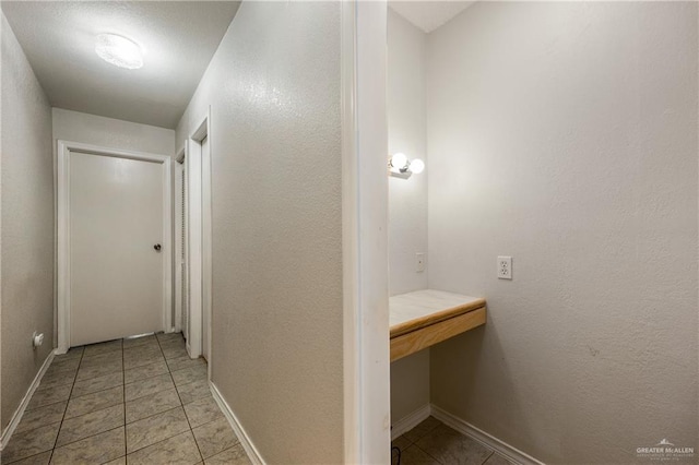 hallway featuring light tile patterned floors