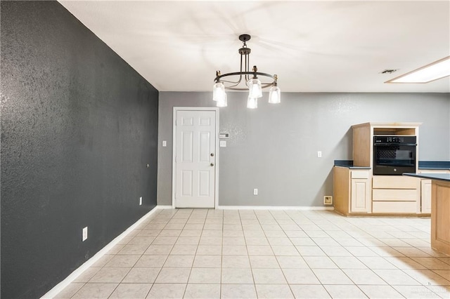 interior space with light tile patterned flooring and a notable chandelier