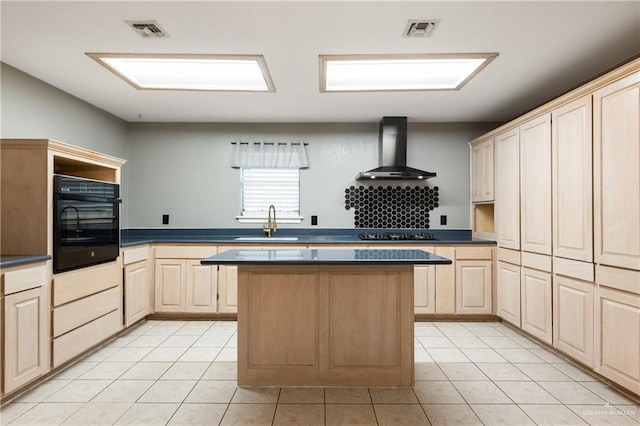 kitchen featuring light tile patterned flooring, sink, oven, light brown cabinets, and wall chimney range hood