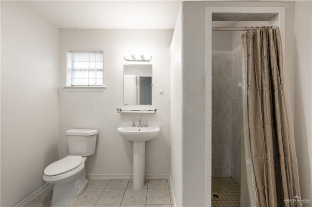 bathroom with tile patterned flooring, toilet, and a shower with shower curtain