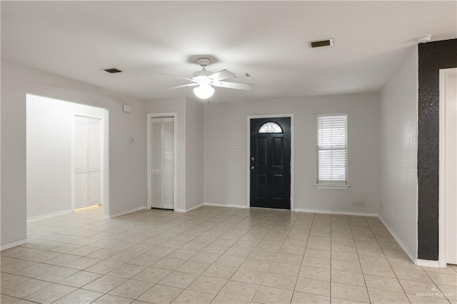 entryway with ceiling fan and light tile patterned floors