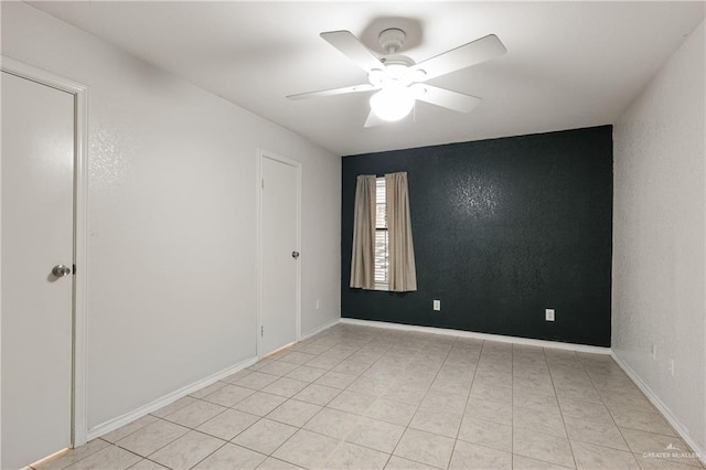 spare room with ceiling fan