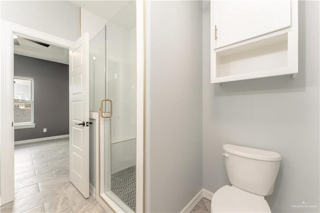 1711 Lago Delton, Edinburg, TX 78542 - bathroom featuring a shower stall, baseboards, and toilet