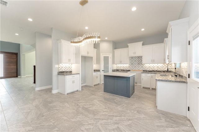1711 Lago Delton, Edinburg, TX 78542 - kitchen featuring tasteful backsplash, a kitchen island, recessed lighting, white cabinets, and hanging light fixtures