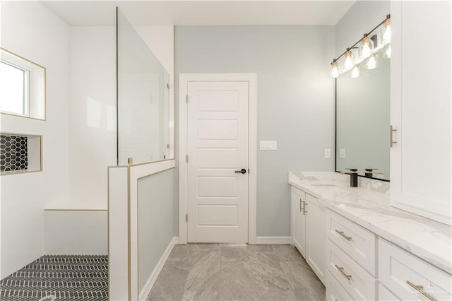 1711 Lago Delton, Edinburg, TX 78542 - full bathroom with marble look tile flooring, vanity, baseboards, and walk in shower