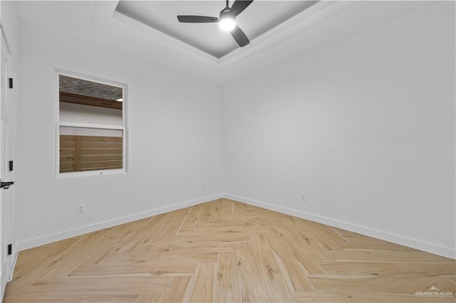 unfurnished room featuring ceiling fan and parquet floors