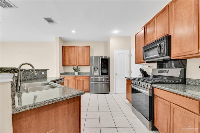 3613 Los Lagos Dr, Edinburg, TX 78542 - kitchen with a sink, light tile patterned floors, stainless steel appliances, and visible vents
