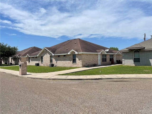 single story home with central AC and a front lawn